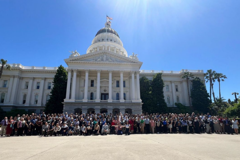 group of people in front of the CA capitol building